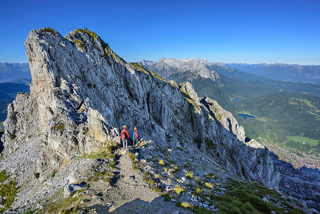 Two women climbing on fixed-rope route Mittenwalder Hoehenweg, fixed-rope route Mittenwalder Hoehenweg, Karwendel range, Upper Bavaria, Bavaria, Germany