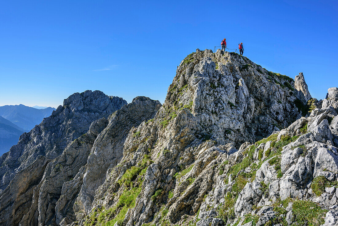 Two women climbing on fixed-rope route Mittenwalder Hoehenweg, fixed-rope route Mittenwalder Hoehenweg, Karwendel range, Upper Bavaria, Bavaria, Germany