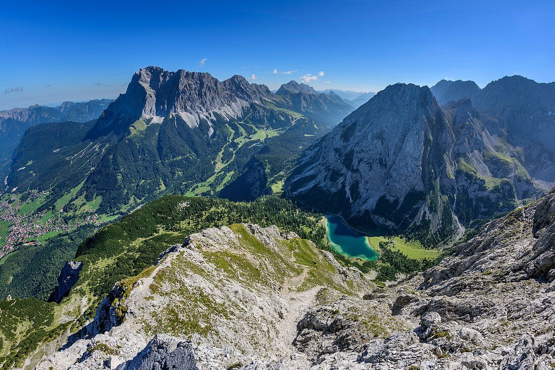 View towards Wetterstein range with Zugspitze and lake Seebensee, from Ehrwalder Sonnenspitze, Mieming range, Tyrol, Austria