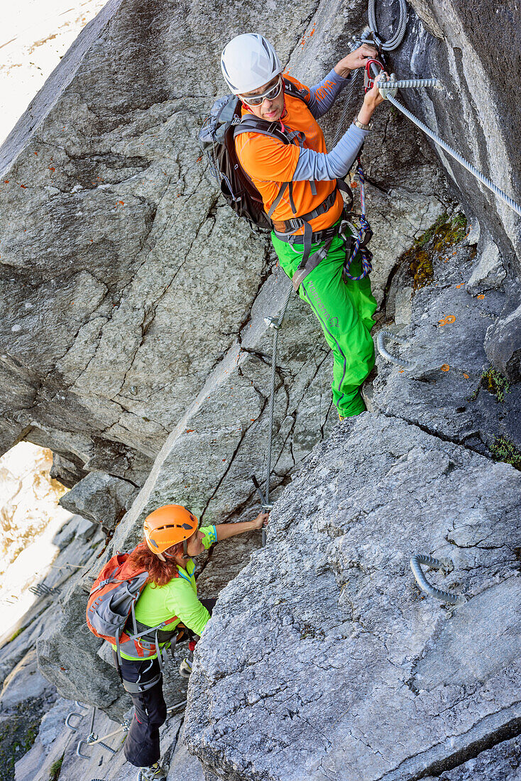 Man and woman descending on fixed-rope route from Richterspitze, Richterspitze, Reichenspitze group, Zillertal Alps, Tyrol, Austria