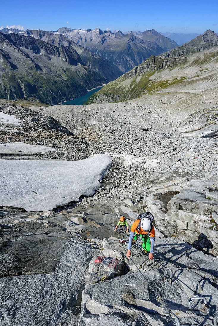 Man and woman descending on fixed-rope route from Richterspitze, Richterspitze, Reichenspitze group, Zillertal Alps, Tyrol, Austria