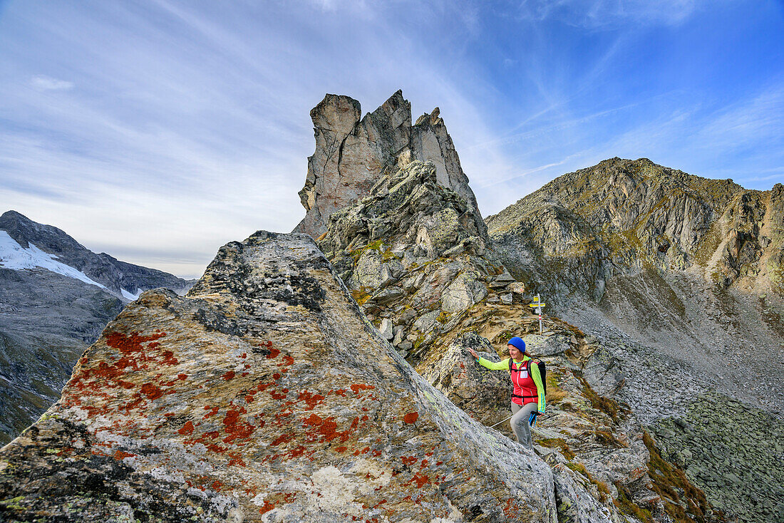 Woman hiking standing in notch, Windbachscharte, Natural Park Zillertal Alps, Dreilaendertour, Zillertal Alps, Salzburg, Austria