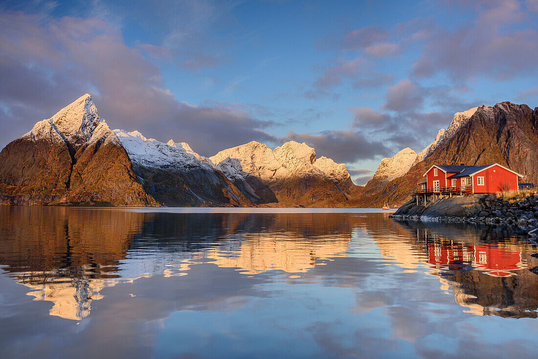 Bay with fisher house, snow-covered mountains in background, Hamnoy, Lofoten, Norland, Norway