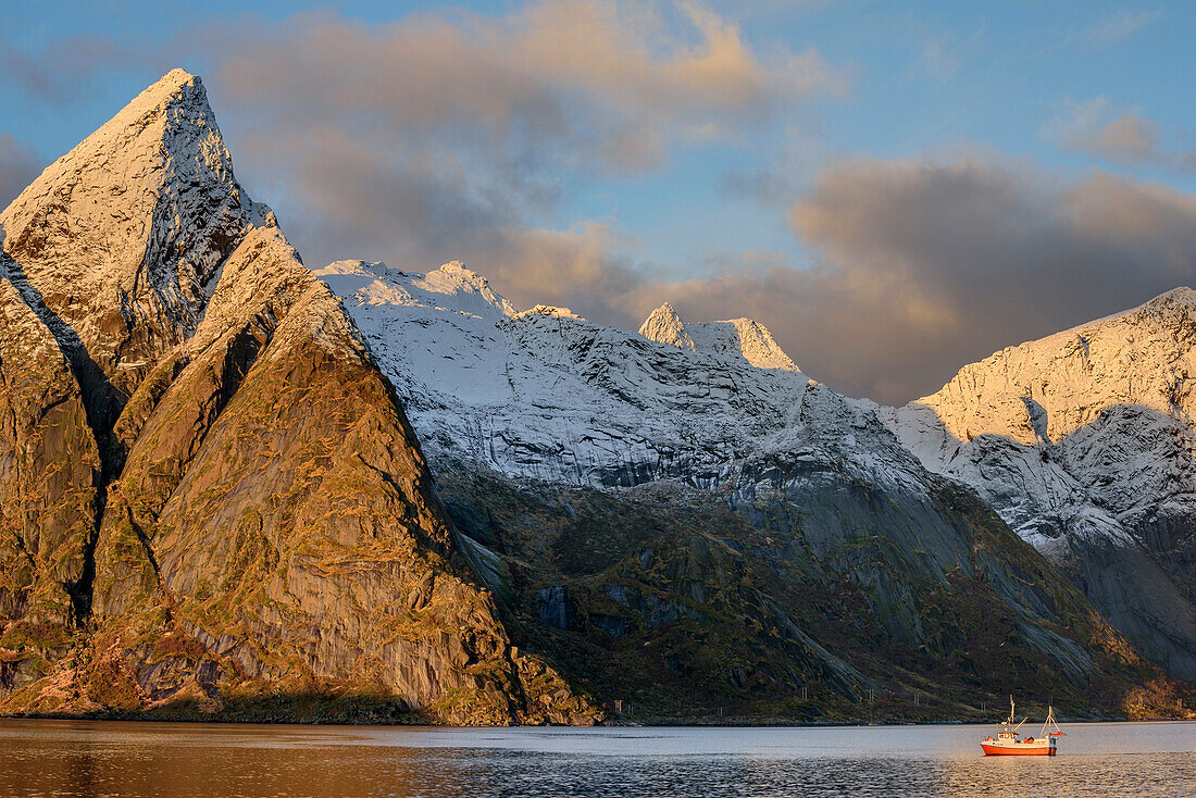 Bay with ship and snow-covered mountains in background, Hamnoy, Lofoten, Norland, Norway