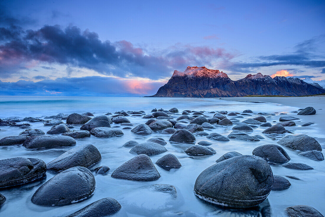 Rocks at beach, mountains in background, Lofoten, Norland, Norway
