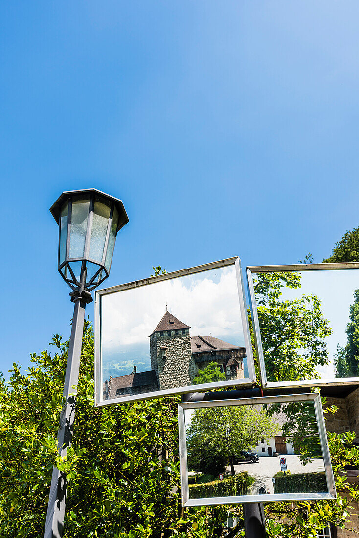 Reflection of Vaduz castle which lies on a rock terrace above the capital of the principality, Vaduz, Liechtenstein