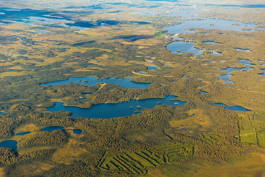 Aerial view of a road passing through low lying land with lakes and ponds, South, central Alaska, Alaska, United States of America