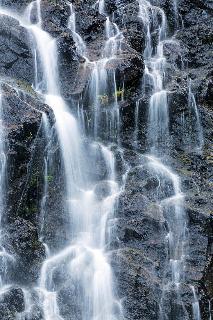 Detail of water cascading down dark rock on Bridalveil Falls in Keystone Canyon, South, central Alaska, Valdez, Alaska, United States of America