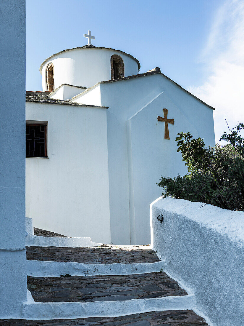 A white church building with crosses and steps, Panormos, Skopelos, Greece