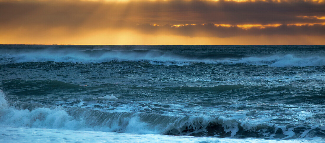 Golden sunset over a west coast sea, Greymouth, South Island, New Zealand