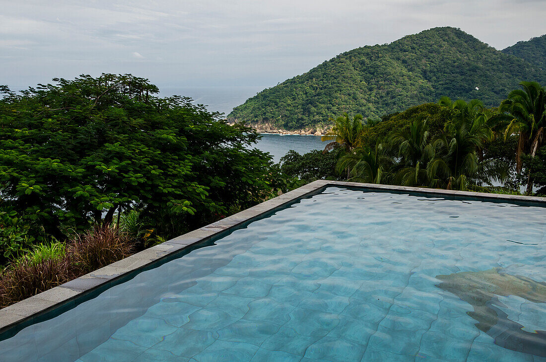 A pool of water with a view of the coastline and lush foliage, Jalisco, Mexico