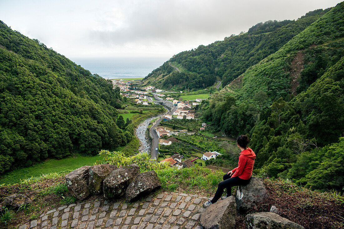 Young woman enjoying the view in Faial da Terra, Sao Miguel, Azores, Portugal