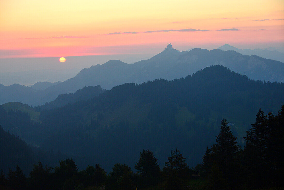 Sunrise at the Hochries hut over Samerberg to Kampenwand, Chiemgau county, Bavaria, Germany