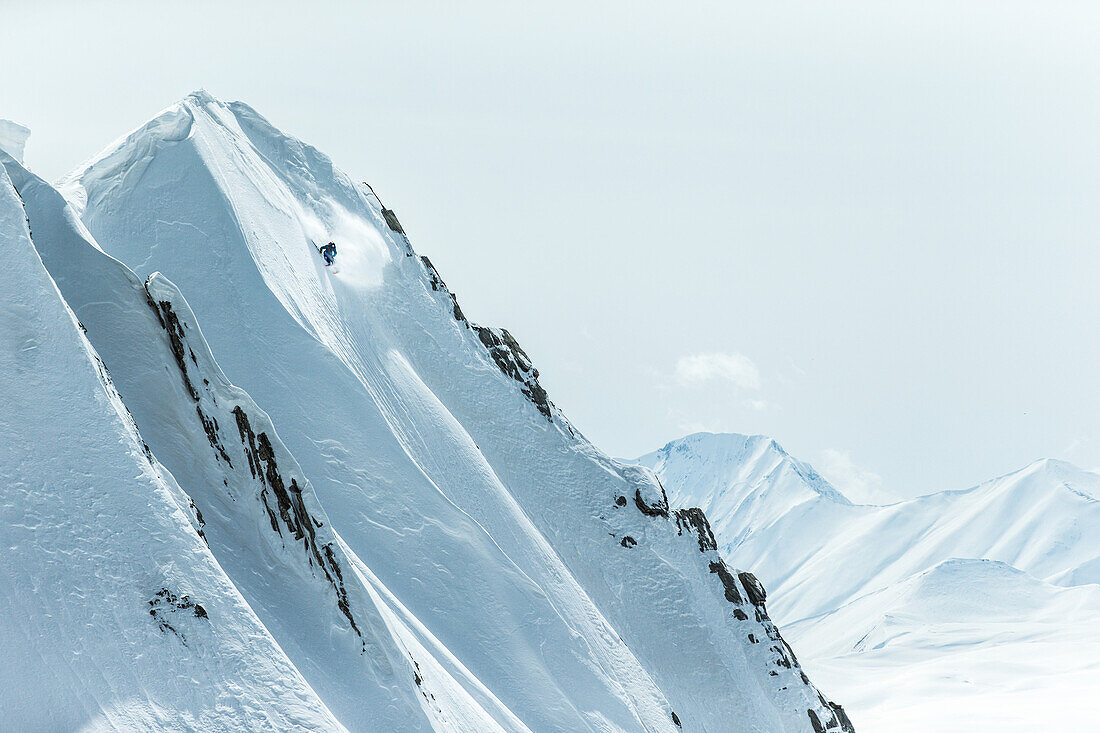 Young male skier riding apart the slopes through the deep powder snow, Gudauri, Mtskheta-Mtianeti, Georgia