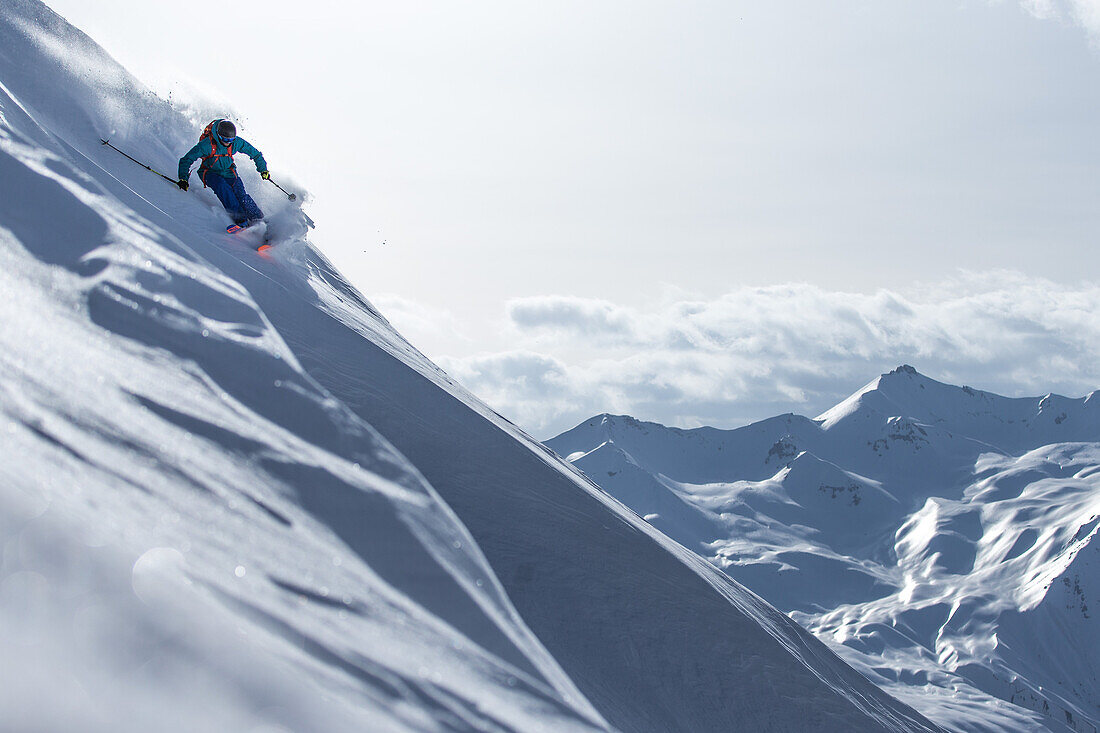 Young male skier riding apart the slopes through the deep powder snow, Gudauri, Mtskheta-Mtianeti, Georgia