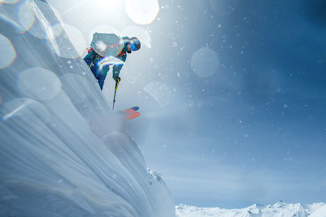 Young male skier standing on a snowdrift in the mountains, Gudauri, Mtskheta-Mtianeti, Georgia