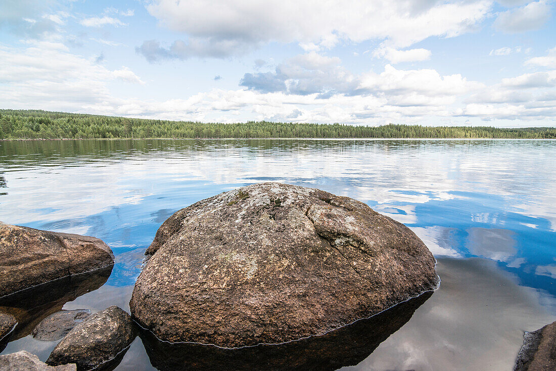 rock  in a lake at a cool summer´s day , lake near Munkfors, Varmland, Sweden
