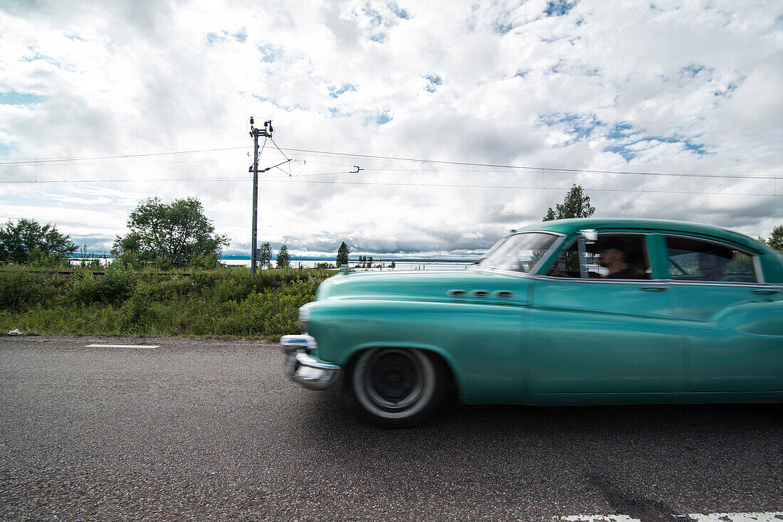 oldtimer passing by on a street in Rattvik, during the classic car week in summertime, Dalarna, Sweden