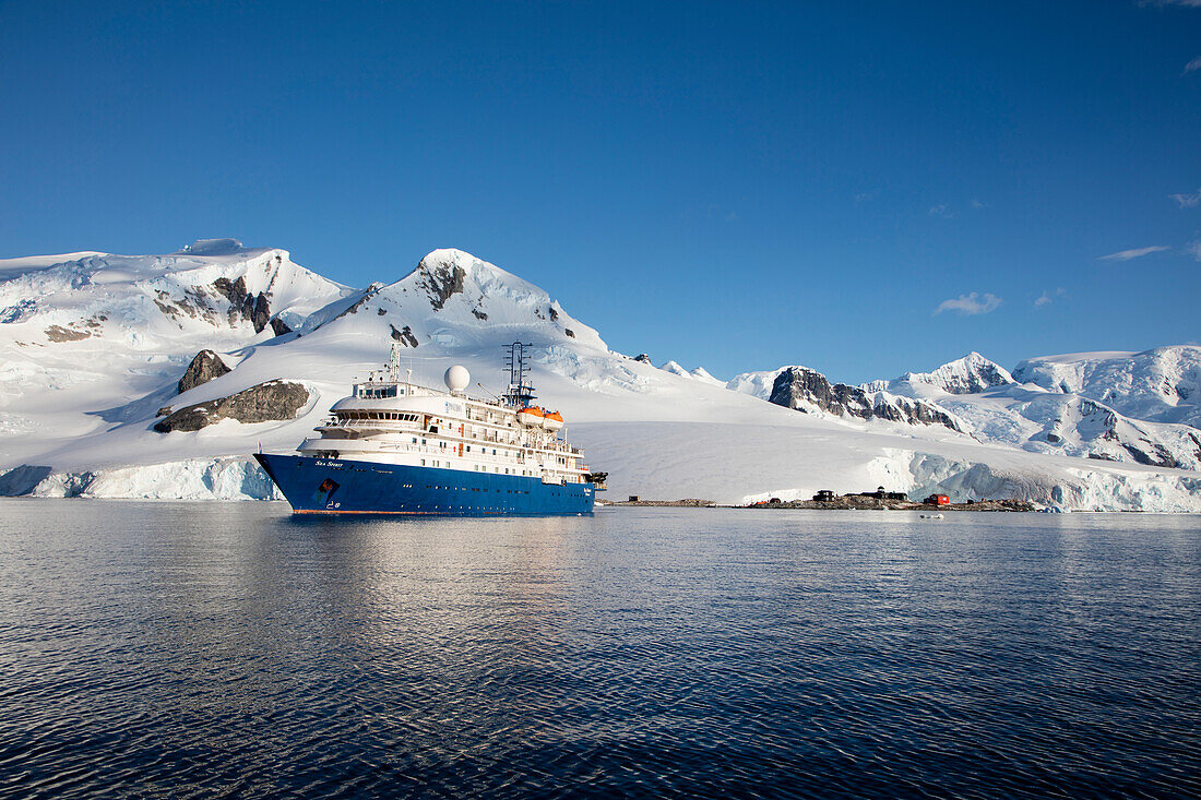 Expedition cruise ship MV Sea Spirit (Poseidon Expeditions) and snow-covered mountains Waterboat Point, near Paradise Harbor (Paradise Bay), Graham Land, Antarctic Peninsula, Antarctica