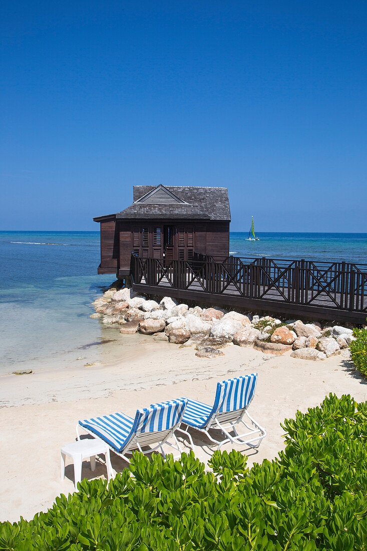 Beach chairs and overwater spa cabana at Half Moon Resort Rose Hall, near Montego Bay, Saint James, Jamaica