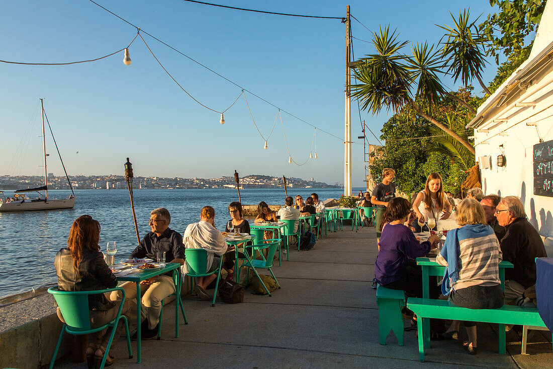 riverfront restaurant Atira te ao Rio, view from south bank of River Tagus, Cacilhas, Almada, Lisbon, Portugal