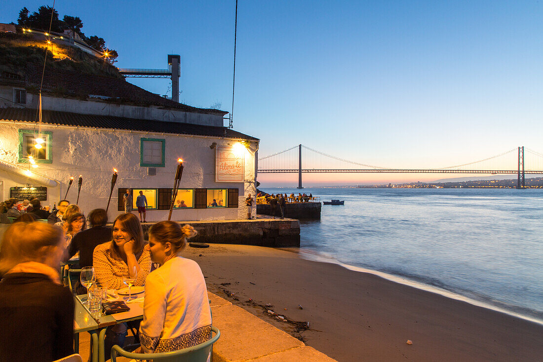 riverfront restaurant Atira te ao Rio, view from south bank of River Tagus, Cacilhas, Almada, Lisbon, Portugal