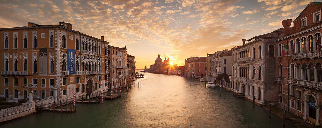 Panoramic view of the Ponte dell'Accademia over the Grand Canal at sunrise, the Palazzo Cavalli-Franchetti left, the Palazzo Contarini Polignac right and the church of Santa Maria della Salute in the background, Dorsoduro, Venice, Veneto, Italy