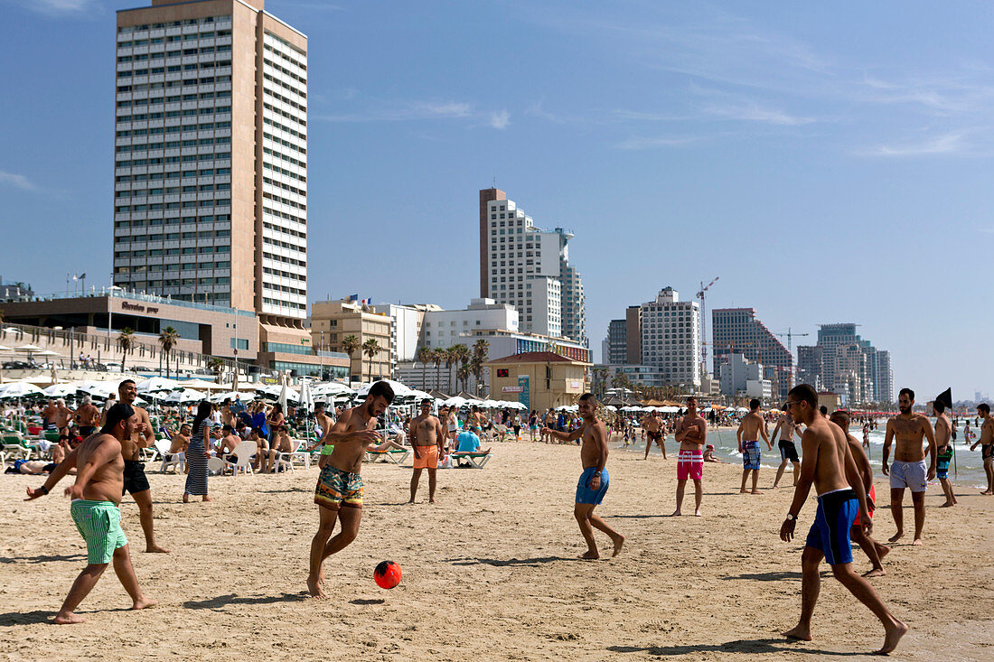 Junge Männer spielen Fußball am Strand, Tel-Aviv, Israel