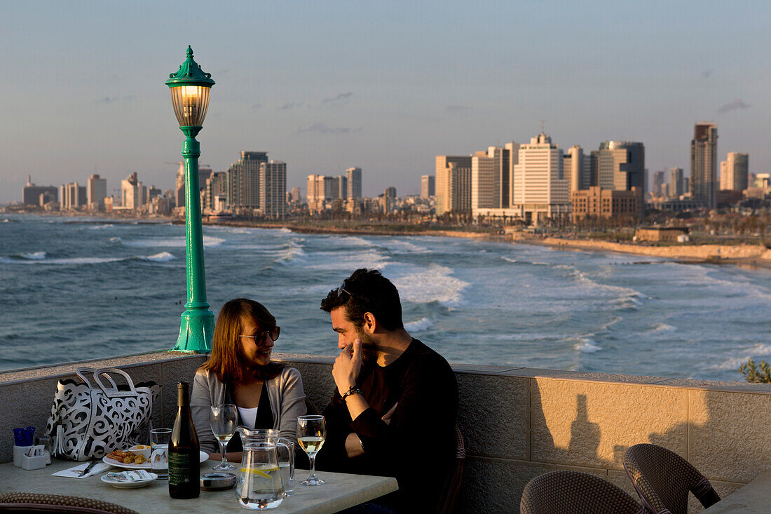 Couple dining in Jaffa overlooking Tel-Aviv, Israel