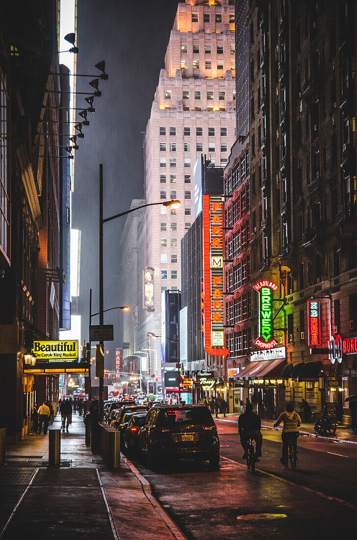 View of Midtown Manhattan Illuminated by Neon Signs at Night, New York City, New York, USA