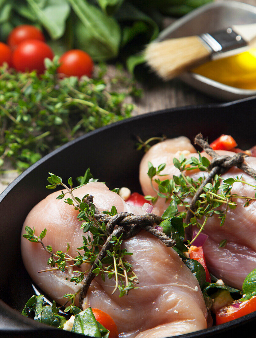Close up of chicken breast wrapped with herbs