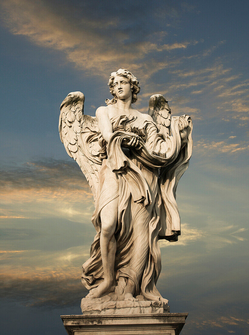 Low angle view of statue under cloudy sky