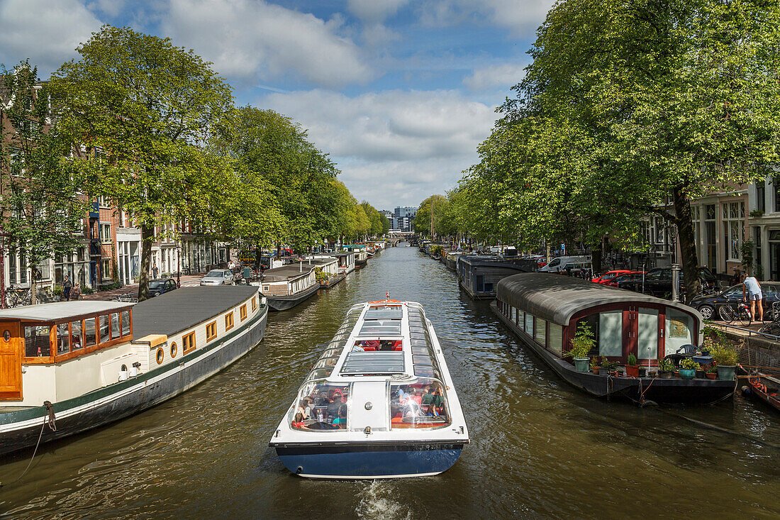 Boat on urban canal, Amsterdam, Holland