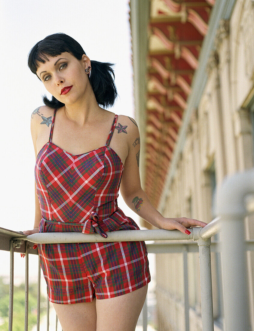Woman wearing retro dress on balcony