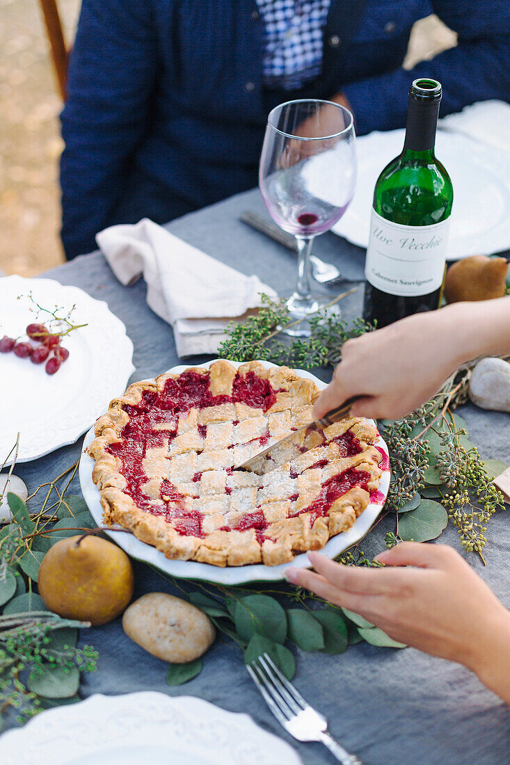 Woman serving pie at outdoor table