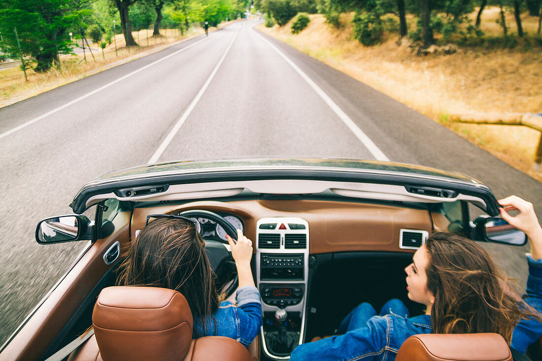 Women driving in convertible