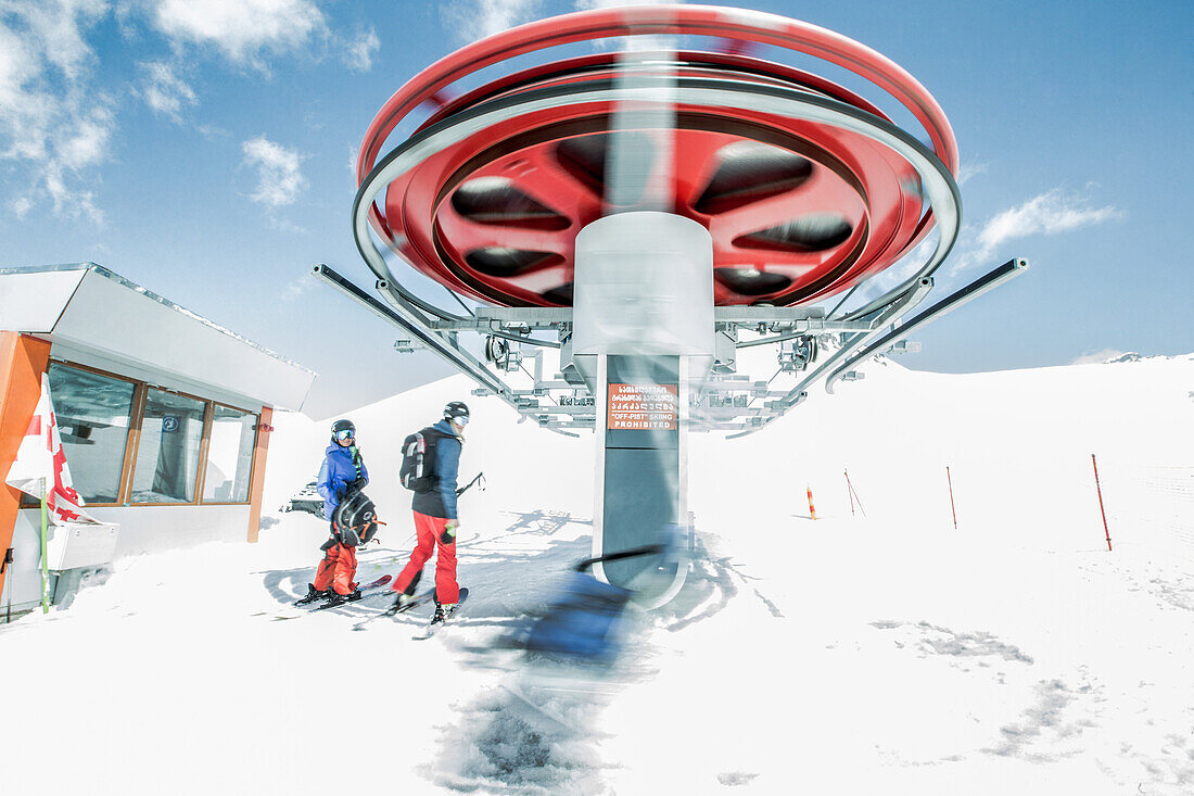 Two young skiers getting in a chairlift, Gudauri, Mtskheta-Mtianeti, Georgia