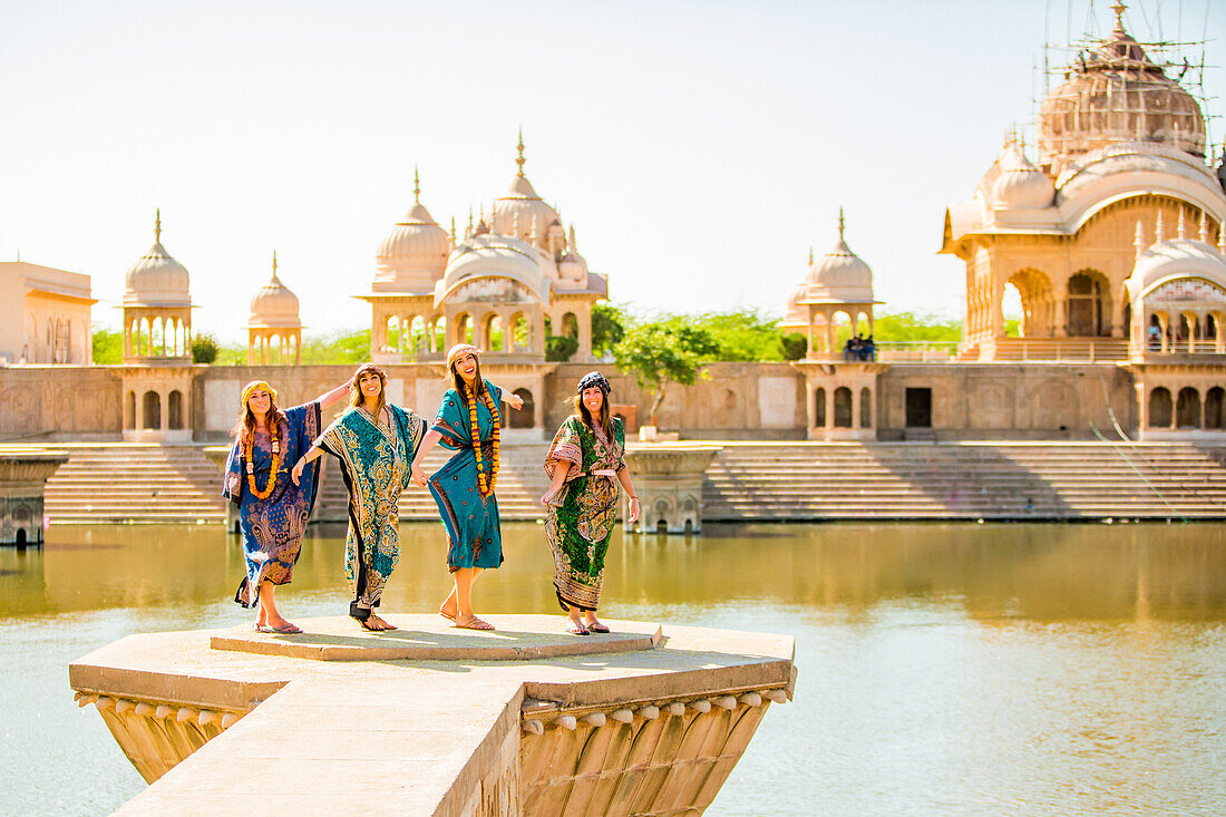 Female tourists stand in front of Temple during Holi Festival, Vrindavan, Uttar Pradesh, India, Asia