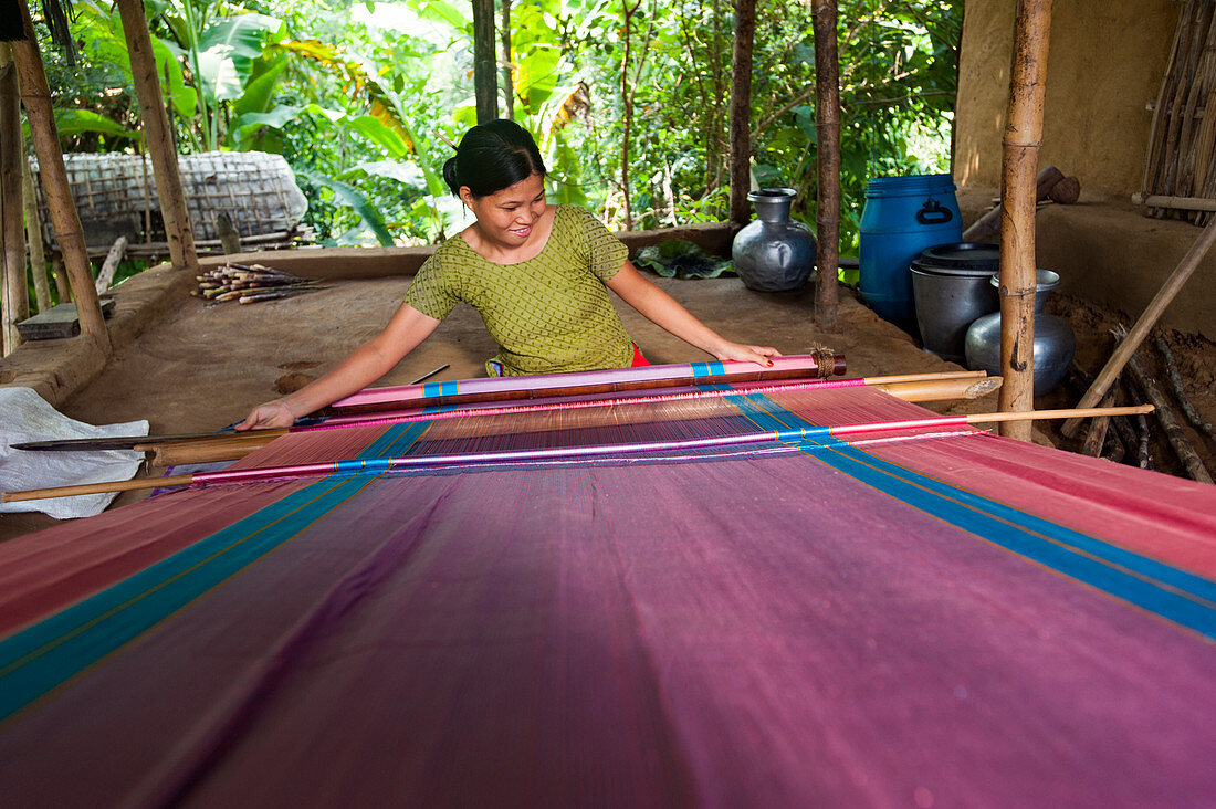 A woman weaves traditional fabric using a hand loom, Chittagong Hill Tracts, Bangladesh, Asia