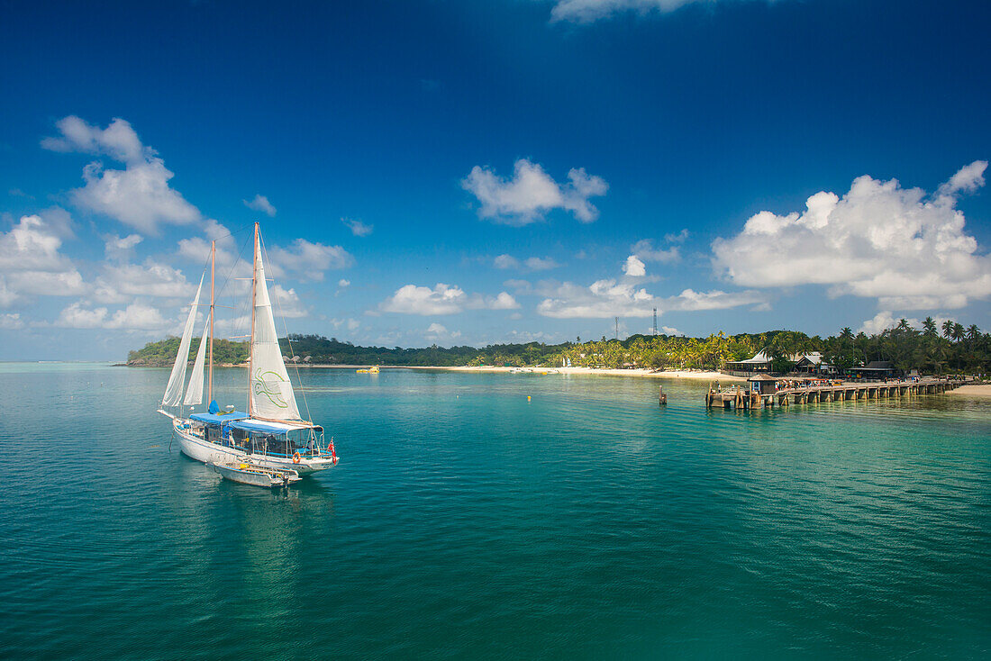 Sailing boat anchoring on Mana Island, Mamanuca Islands, Fiji, South Pacific