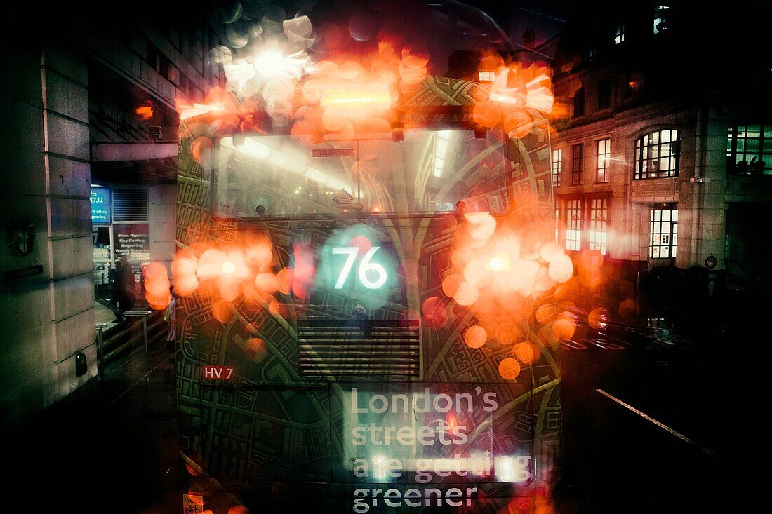 Rear view of bus 76, seen from another bus, with light reflections on glass in a rainy day. London, England