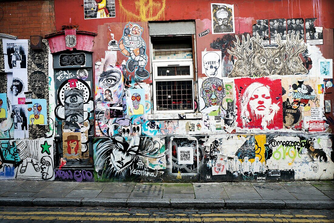 Street art and Graffiti on house wall. Grimsby St. East End, London, England