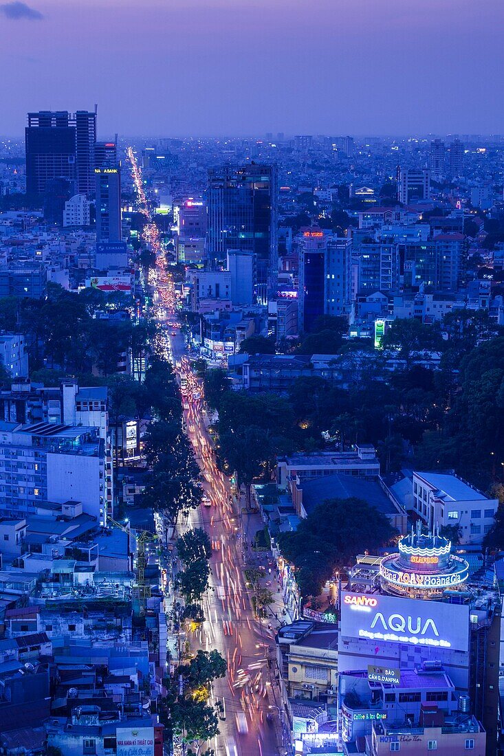 Vietnam, Ho Chi Minh City, elevated skyline view above Cach Mang Thang Tam Avenue, dusk.