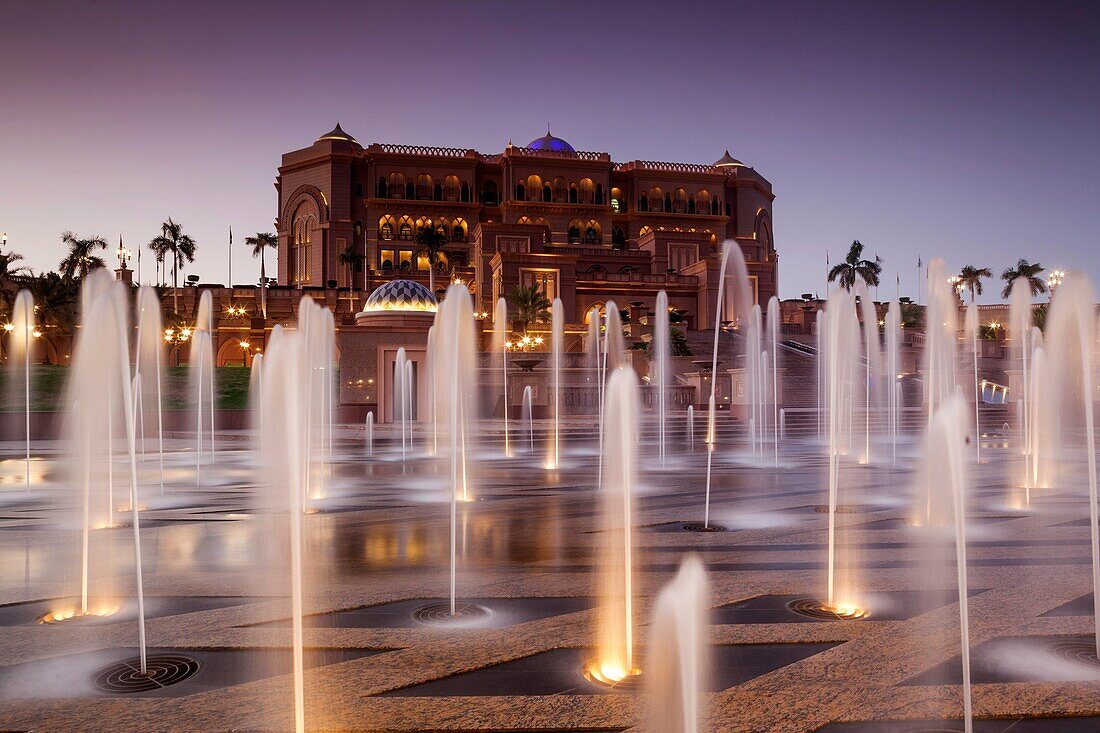UAE, Abu Dhabi, Emirates Palace Hotel and fountains, dusk.