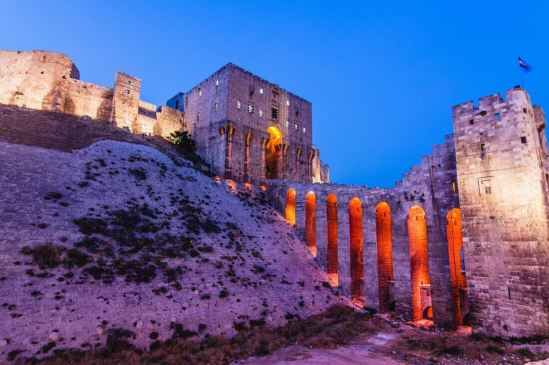 Floodlit keep and walls of the Citadel of Aleppo, Syria.