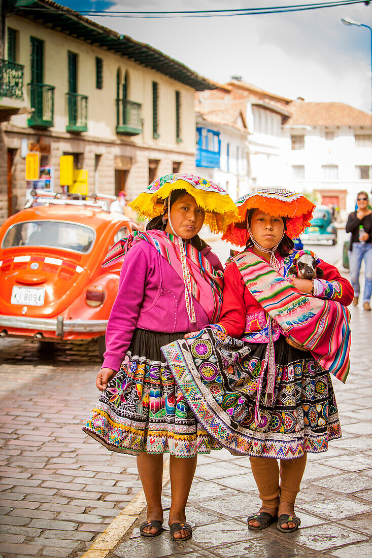 Two Cholita Peruvian girls and their lambs, Cusco, Peru, South America