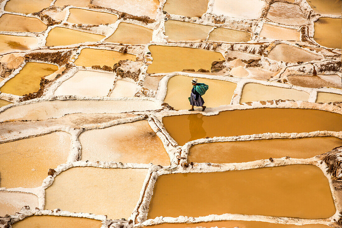 Woman mining salt, Salineras de Maras, Maras Salt Flats, Sacred Valley, Peru, South America