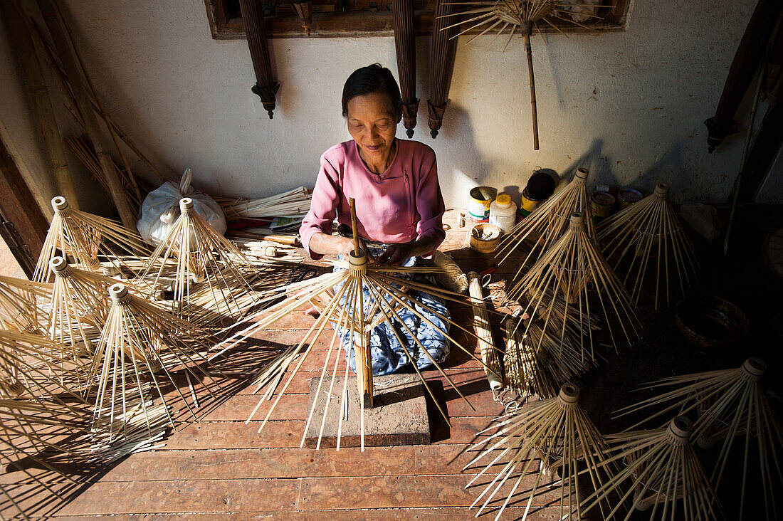 A woman makes umbrellas from bamboo using a traditional method in Shan State, Myanmar (Burma), Asia