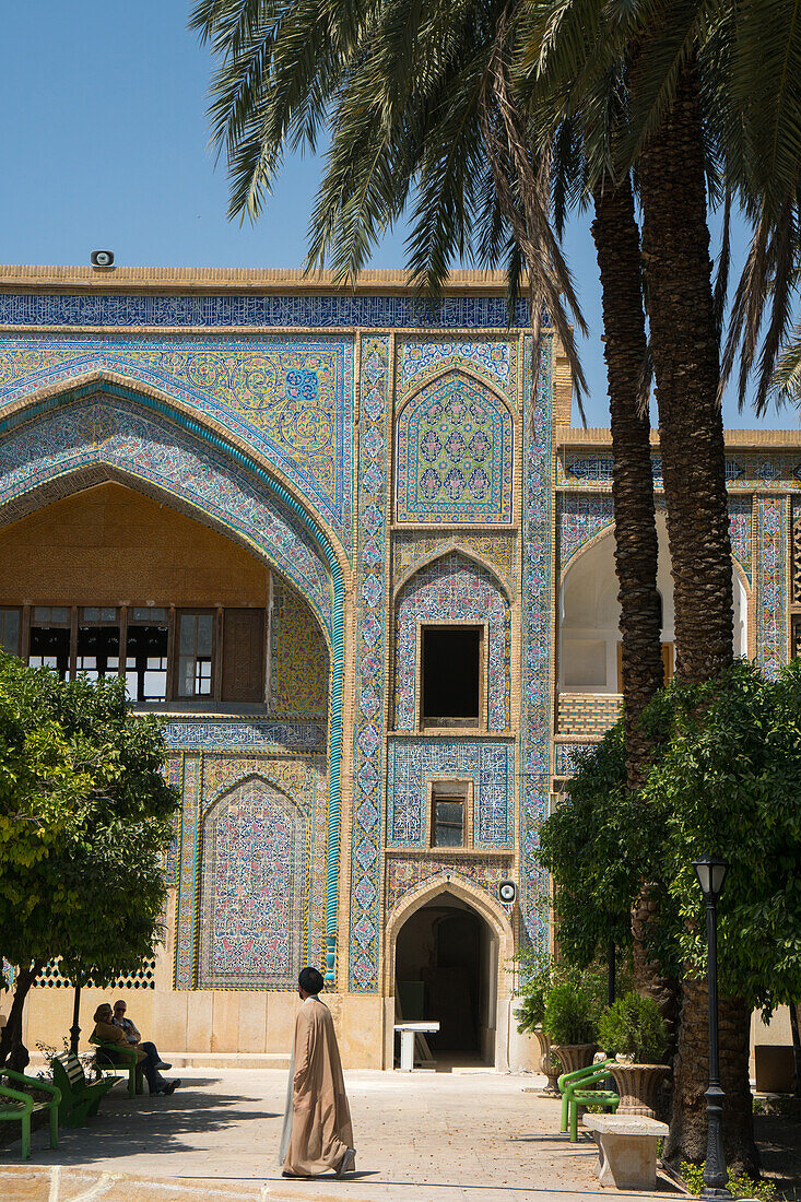 Mullah crossing the courtyard of Madraseh-ye Khan, Shiraz, Iran, Middle East