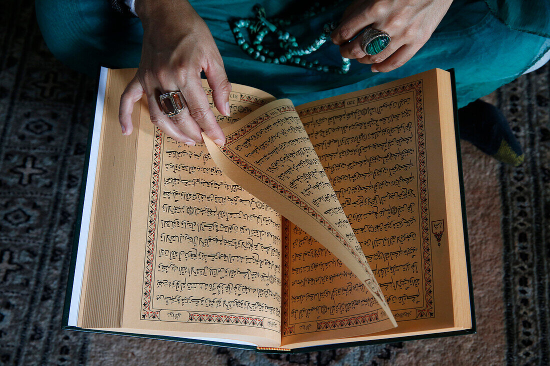 Muslim woman reading Kuran, Montrouge, Hauts-de-Seine, France, Europe